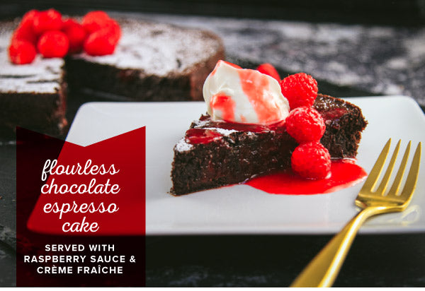 Flourless Chocolate Cake topped with raspberries and whipped cream. 