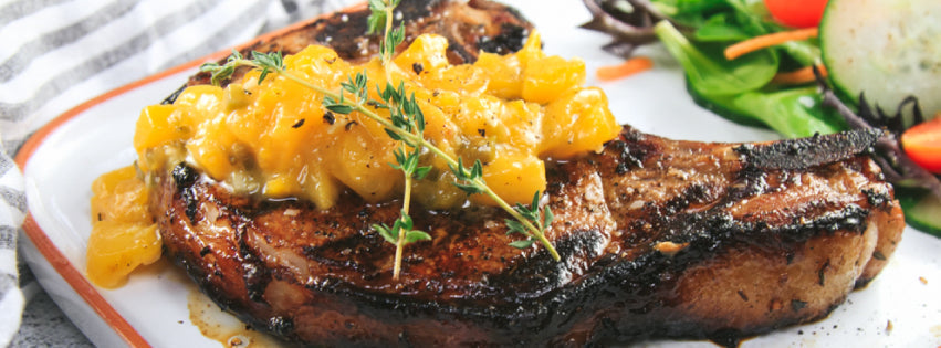 Marinated Bone-in Pork Chops on the Grill with a Spicy Peach Sauce