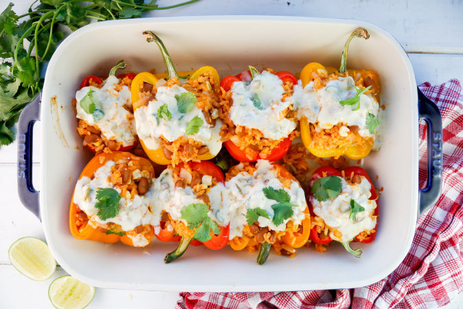 Rice and Bean Stuffed Bell Peppers with Green Chile Queso
