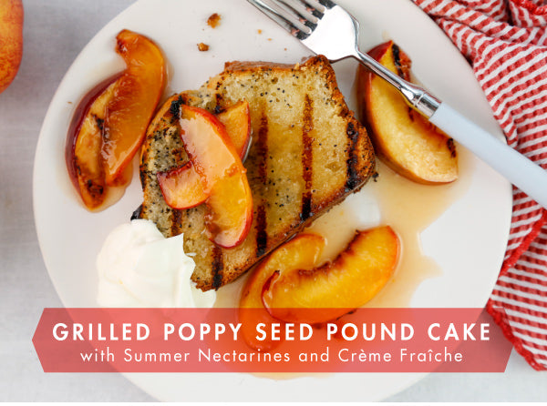 poppyseed loaf grilled, topped with peaches and creme fraiche on a white serving plate