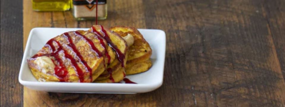 Pumpkin Pancakes with a Spiced Butter & Cranberry Drizzle